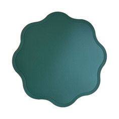 a green placemat with scalloped edges on a white background, top view