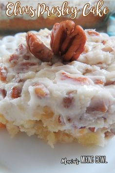 a close up of a piece of food on a plate with some pecans in the background