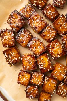 tofu with sesame seeds on top and text overlay that reads delicious baked tofu marinated + vegan