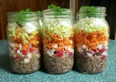 three mason jars filled with different types of food