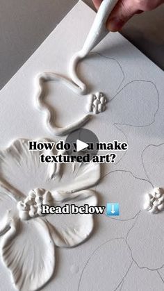 a person is painting flowers on a piece of paper with the words how do you make textured art?