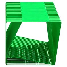 a green side table sitting on top of a white floor