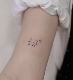 a person with a tattoo on their arm that has numbers and arrows drawn on it