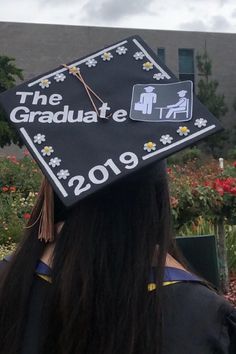 a graduate's cap that reads the graduatee is in front of some flowers