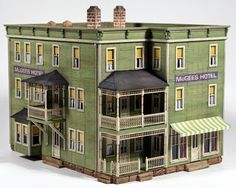 a model of a green building with balconies on the top and second story