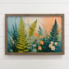 a painting hanging on the wall with flowers and plants in it's center frame