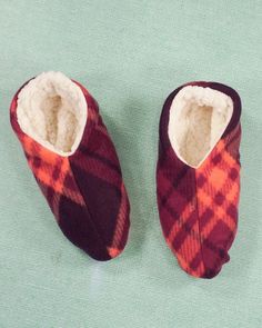 a pair of slippers sitting on top of a green surface