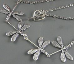 Four dragonflies necklace. Four flying dragonfly/butterfly/insect in one direction. Dragonflies are sterling silver plated. Connected to silver chain and heart toggle clasp. Feel free to pick different charms to either personalized or decorate the necklace: https://www.etsy.com/listing/91915088/personalized-initial-custom-add-on?ref=shop_home_active_2 https://www.etsy.com/listing/529516757/personalized-birthstone-custom-add-on? ref=shop_home_active_1 https://www.etsy.com/listing/600994579/person Handmade Dragonfly Necklace For Gifting, Adjustable Dragonfly Necklace For Gifting, Dragonfly Wedding, Adjustable Dragonfly Necklace For Gift, Adjustable Sterling Silver Dragonfly Necklace, Friend Anniversary, Blue Stones Jewelry, Bohemian Silver Dragonfly Necklace, Celtic Earrings