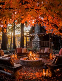 an outdoor fire pit surrounded by chairs and trees with fall leaves on the ground around it