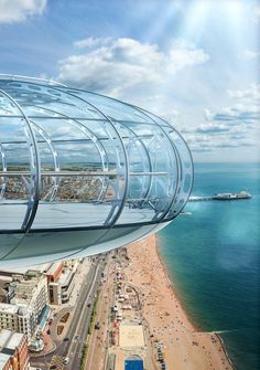 an aerial view of the beach and ocean from a glass dome on top of a building