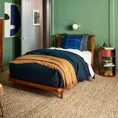 a bedroom with green walls and carpeted flooring