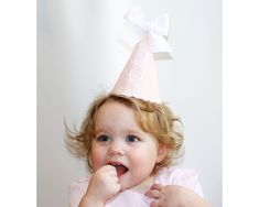 "Are you looking for the perfect birthday party hat? Maybe one that will match her outfit perfectly and can be used for several years? This hat is perfect! Our classic bow party hat features sweet details like decorative edging, a classic script font, and grosgrain bow. This party hat is made from 100% pure European linen, a natural luxury that is sustainable and biodegradable. DETAILS *100% linen *Blush linen with white embroidery *Fully sewn to ensure that it lasts for many birthdays * Choose