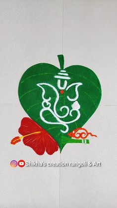 an artistic painting on the side of a white wall with green leaf and flower design