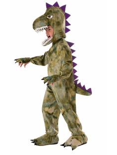 a child in a dinosaur costume is standing and pointing to the side with its mouth open