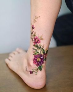 a close up of a person's foot with flowers on it