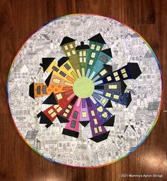 a circular table top with many different colored houses on it