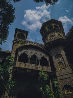 an old building with two towers and balconies