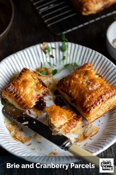 a white plate topped with cranberry pastries on top of a wooden table