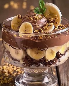 a chocolate dessert with bananas and nuts on top