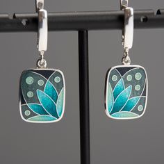 "Weight - 7 gr (approx) Length - 34 mm/1.33\" (including ear wire) Width - 15 mm/0.59\" Materials - Sterling Silver, Fine Silver, Cloisonne Enamel. Rectangle earrings with turquoise flower. Small and light earrings perfect fits for everyday wearing. The base underneath the enamel layer is engraved which gives my pieces even more loveliness and charm. Latch back ear wires has a safe lock and also made from Sterling Silver. Earrings covered with hot transparent enamel. Enamelling is an art of deco Torch Fired Enamel Jewelry, Enameling Jewelry, Cloisonne Enamel Jewelry, Lily Earrings, Cloisonne Jewelry, Bijoux Fil Aluminium, Safe Lock, Rectangle Earrings, Light Earrings