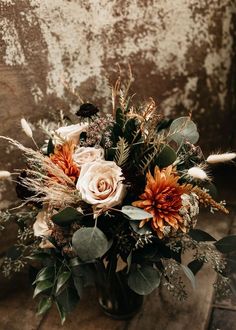 a vase filled with flowers on top of a wooden table