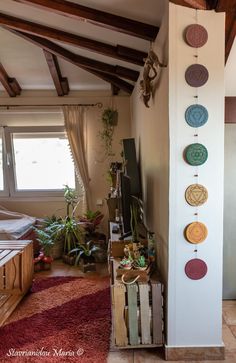 a living room filled with lots of furniture next to a wall mounted clock on the side of a building