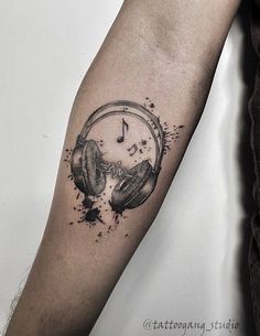 a tattoo with headphones and music notes on it