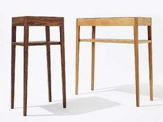 two wooden stools sitting next to each other