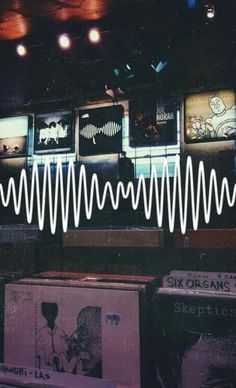 an image of sound waves on display in a music store with record players and records