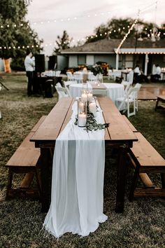 a long wooden table with candles on it