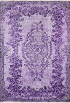 a purple rug with an ornate design on it