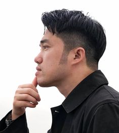 The two-block haircut is a great base for any kind of style. This version includes extended but shaved sideburns, and the top part of the hair is parted in the middle showcasing curtain bangs. The only requirement needed is to grow the hair long enough, around 2 to 3 inches, to be able to part it in the middle. Wear sans facial hair and accessories for a clean look. It will suit most face shapes. Haircuts For Round Faces Men Asian, Korean Men Hairstyle Short Round Faces, Shaved Sideburns, Asian Man Haircut Oval Face, Asian Male Haircut Round Face, Asian Men Short Hairstyle Round Faces, Round Faces Men, Haircuts For Round Faces Men