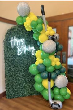 a golf themed birthday balloon arch