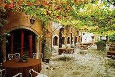 an outdoor dining area with tables and chairs