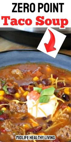 a blue bowl filled with taco soup on top of a wooden table