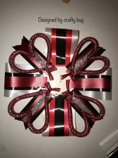 the ribbon is wrapped in red, black and silver strips