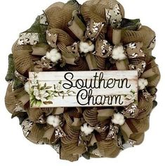 a wreath with the words southern charm written in black and white on it, surrounded by flowers