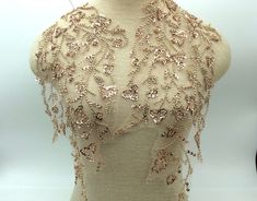 Elegant and enchanting, this rose gold appliqué features intricate beadwork that adds a touch of glamour to any ensemble. The delicate craftsmanship and shimmering beads create a timeless accessory, perfect for elevating your style with a subtle yet captivating charm. Whether adorning a gown or enhancing a clutch, this beaded rose gold appliqué is a versatile and sophisticated embellishment that effortlessly complements any fashion statement. NOTE We try our best to match the colour on your screen to the natural colour of the fabric but due to different lighting on different computer screens colours may vary. Gold Sequin Fabric For Evening, Elegant Gold Beaded Sequin Fabric, Elegant Embellished Gold Sequin Fabric, Elegant Gold Embellished Sequin Fabric, Elegant Gold Sequin Fabric For Festive Occasions, Gold Sequin Fabric With Pearl Embroidery For Party, Gold Embellished Sequin Fabric For Evening, Embroidered Gold Sequin Fabric For Evening, Gold Embroidered Sequin Fabric For Evening