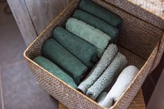 a basket filled with lots of green towels