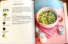 an open book with soup in it on top of a table