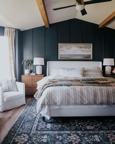 a bedroom with blue walls and white furniture