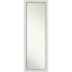 a white door with a mirror on the front and bottom panel, in an empty room