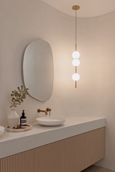 a bathroom with two sinks and a large mirror on the wall above it's counter