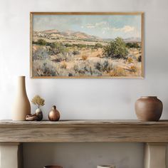 a painting is hanging on the wall above a mantle with vases and other items