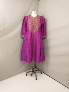 "Gorgeous vintage eighties/nineties Indian women's Kurta - Kurti tunic. Very pretty and quite unusual. Beautiful embroidered detail. Handmade, Indian. Exact fabric and cleaning recommendations unknown, probably rayon could be silk. Pull over the head, no zipper. Two layers, top is fairly opaque and inner cotton layer fairly sheer. Beautiful bright deep magenta pink color, gold edging. Green highlights on the bodice detail. Lg equivalent Western sizing - please go by the actual measurements. Exce Traditional Pink Tunic For Festive Occasions, Long Sleeve Yoke Kurta For Festivals, Festive Purple Tunic Dress, Bohemian Festive Kurta With Yoke, Bohemian Kurta With Yoke For Festive Occasions, Purple Bohemian Kurta For Festive Occasions, Festive Bohemian Kurta With Yoke, Purple Bohemian Kurta For Eid, Festive Bohemian Kurta With Short Sleeves