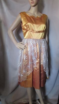 SALE! 10% OFF! Unique special event dress in burnished gold and silver metallic lace. This is home tailored from an estate of a home economics teacher.  She had an extensive closet of home tailored clothing.  This is one example--a little more unusual.  The dress is in the gold bonded satin which allows for a heavier weight. It has a scalloped scoop neckline leading to a 1" empire style band. At the natural waist the skirt of the dress is in wide pleats. The lacy over-skirt is attached to the wa Gold Embroidered V-neck Dress, Lace Overskirt, Event Dress, Special Event Dresses, Dress Gold, Gold Satin, Metal Lace, Empire Style, Gold Dress