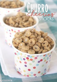 three cups filled with cereal sitting on top of a white table covered in polka dot paper