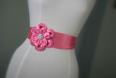 "An accessory to complement your beautiful wedding dress Made of satin fabric with flowers and belt made of satin. In the middle of the flower button is used the crystal. Flower size is approximately 5 \"dimensions. The belt length is approximately 80\"dimensions Flower fitted with lapel pins. Then, a flower can be used as a separate lapel pin. Please feel free to contact for questions and requests. PACKAGE ARE SENT BY FAST SHIPPING COMPANY WITHIN 3 TO 4 BUSINESS DAYS, TO UNITED STATES, TO CANAD