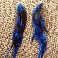 These earrings were crafted  using blue and black saddle feathers and silver chain. About 9" in length from the top of the surgical steel ear wires to the bottom of the feathers. Ear wires are surgical steel.Made to order. Please see my shop policies or shop announcement for current turn around time. If you need your order asap please let me know, I can usually accommodate rush orders.*****Check out the huge selection of feather jewelry and accessories in my shop! Please feel free to contact me Blue Feather Earrings Gift, Blue Feather Earrings For Gift, Blue Feather Earrings As Gift, Black Saddle, Rooster Feathers, Boho Feathers, Hippie Earrings, Feather Jewelry, Blue Feather