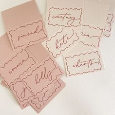 four pink and white cards with writing on them